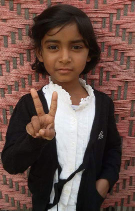 girl-with-short-hair A school girl with a hand in her pocket making the peace sign